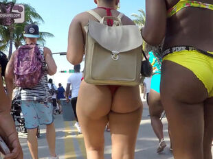 Large arse lady in swimsuit ambling public street